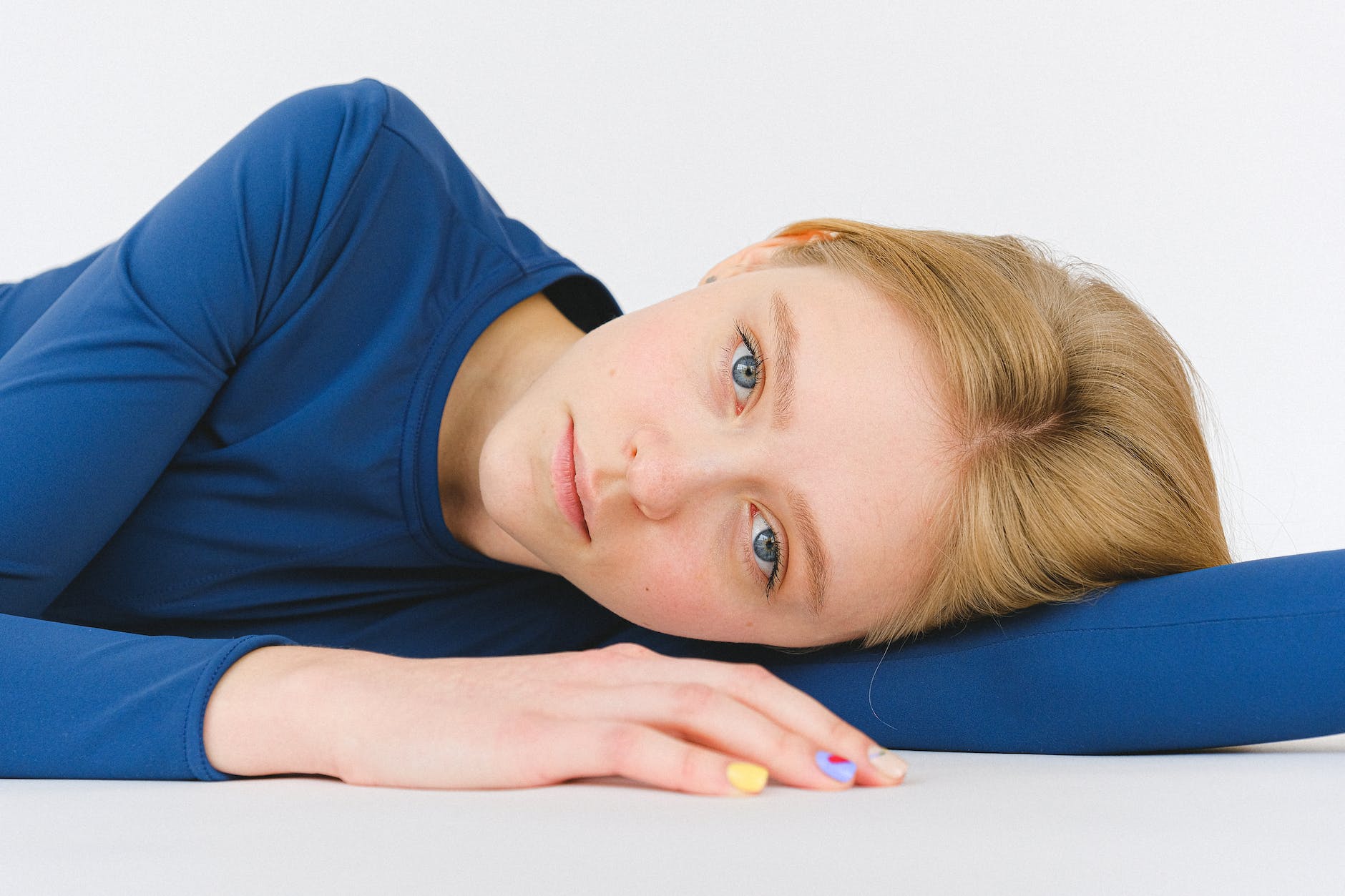 calm woman lying on white surface
