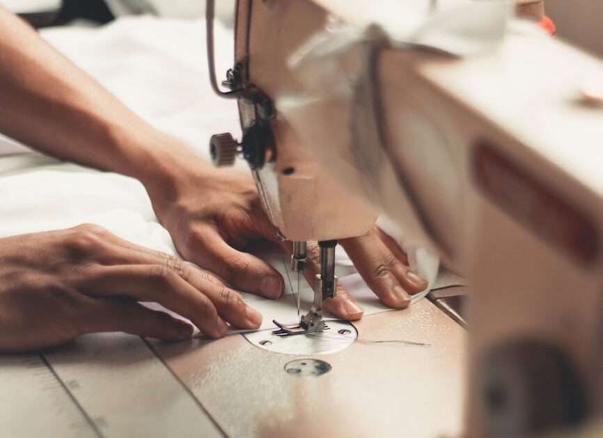 person holding sewing machine