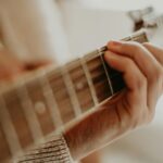 person playing guitar during daytime
