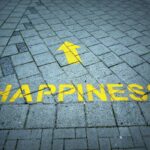 a brick sidewalk with a yellow arrow painted on it