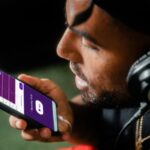 man holding blue and white smartphone