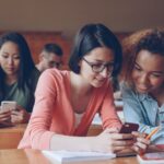 Students looking at phones in a lecture hall